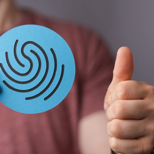A man holding a sign of a fingerprint- the concept of privacy